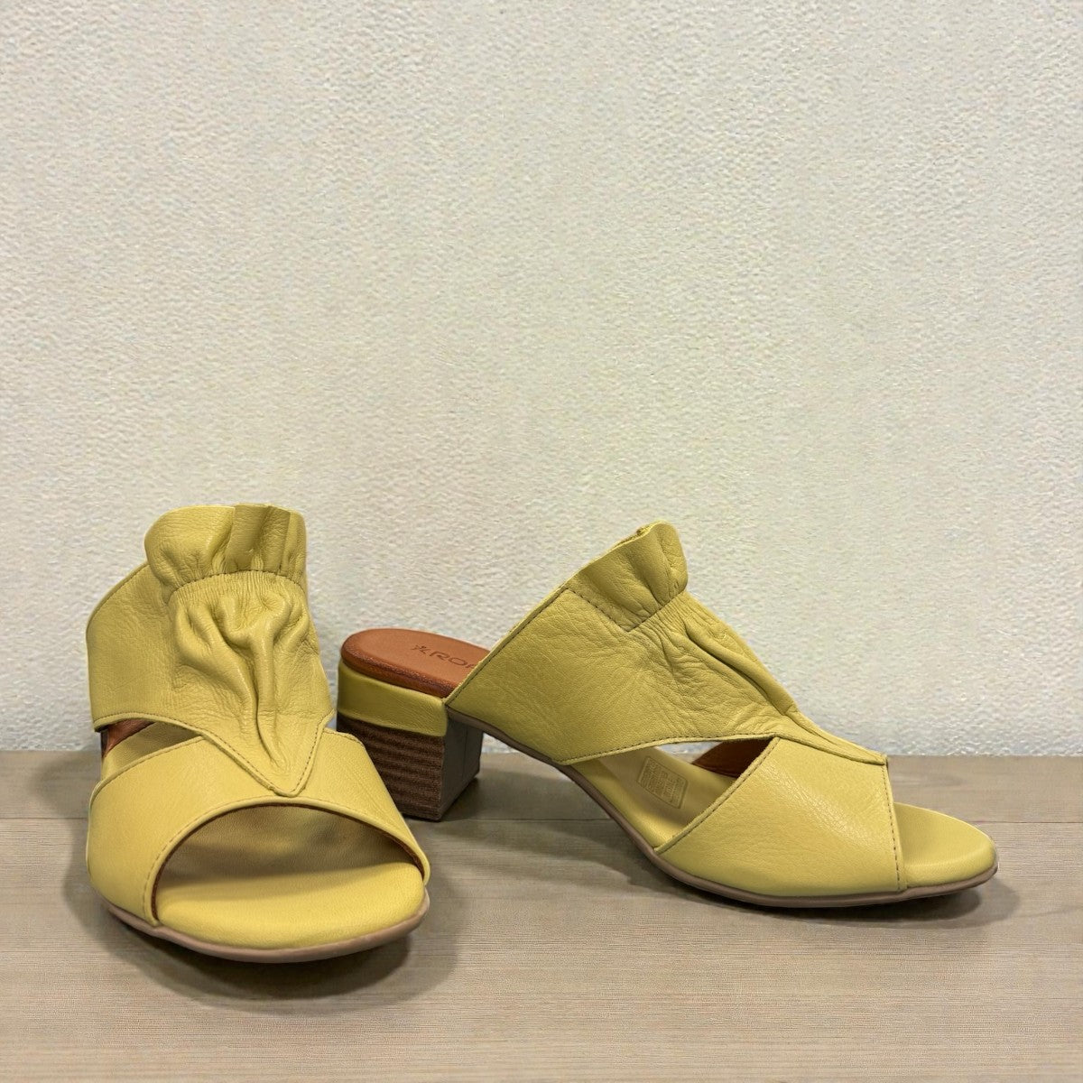 Roamers Zola pistachio green leather slide sandals with a low block heel and gathered strap detail.
photo of the front side