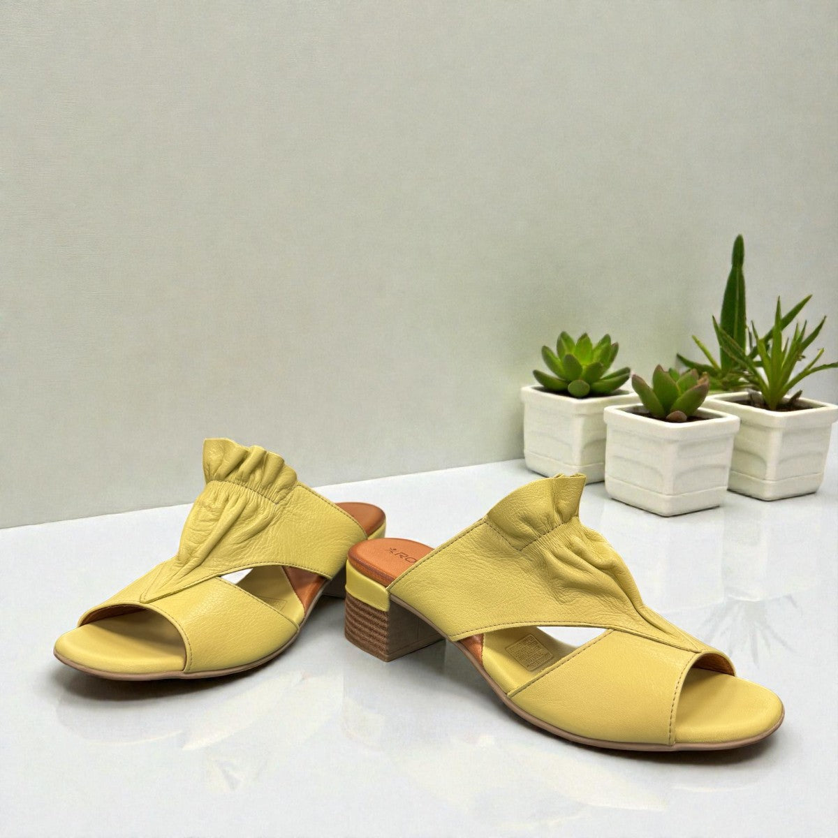 Roamers Zola pistachio green leather slide sandals with a low block heel and gathered strap detail.
photo of the front side