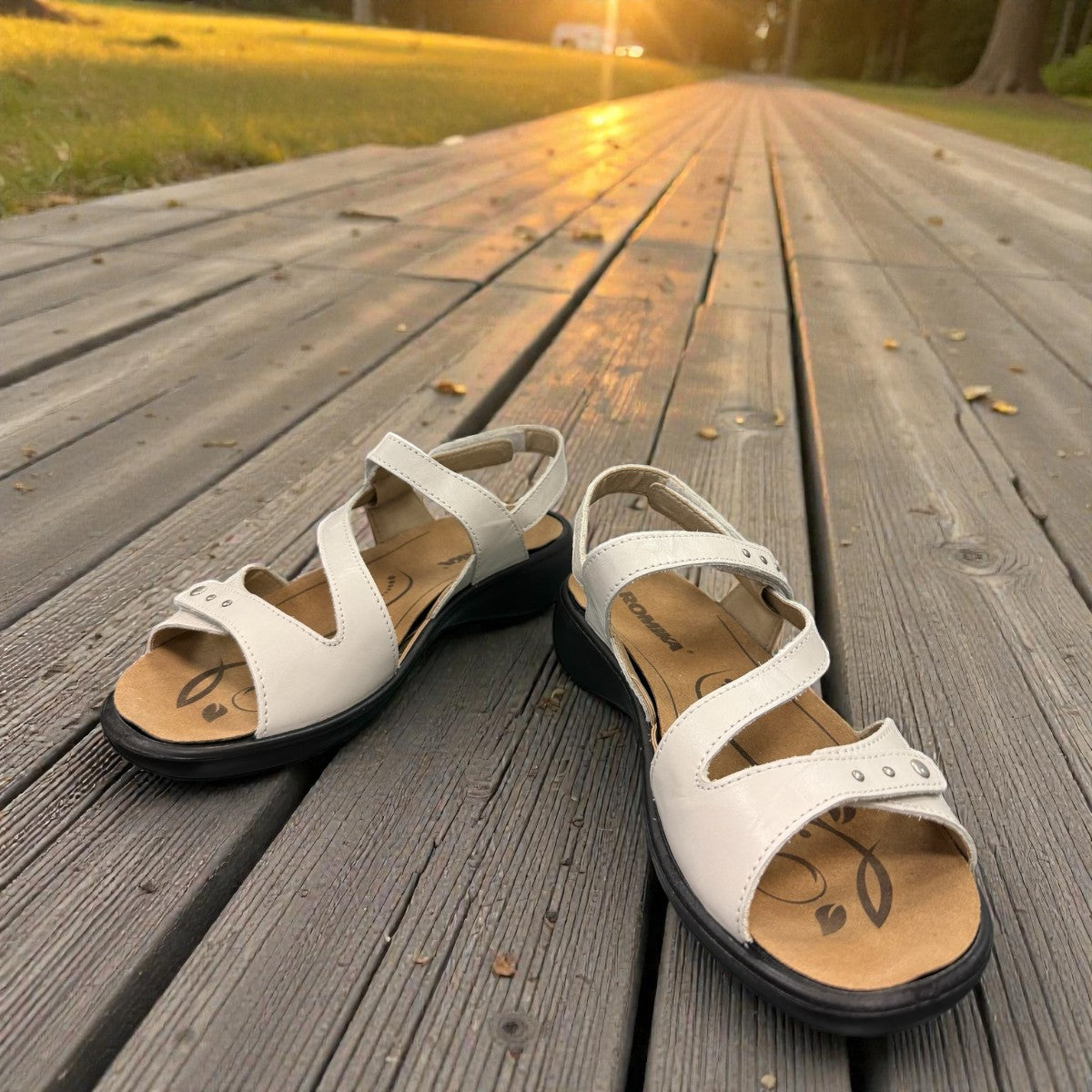 Romika Ibiza 70 white leather sandal with three adjustable hook and loop straps and dark outsole.
photo of the front side