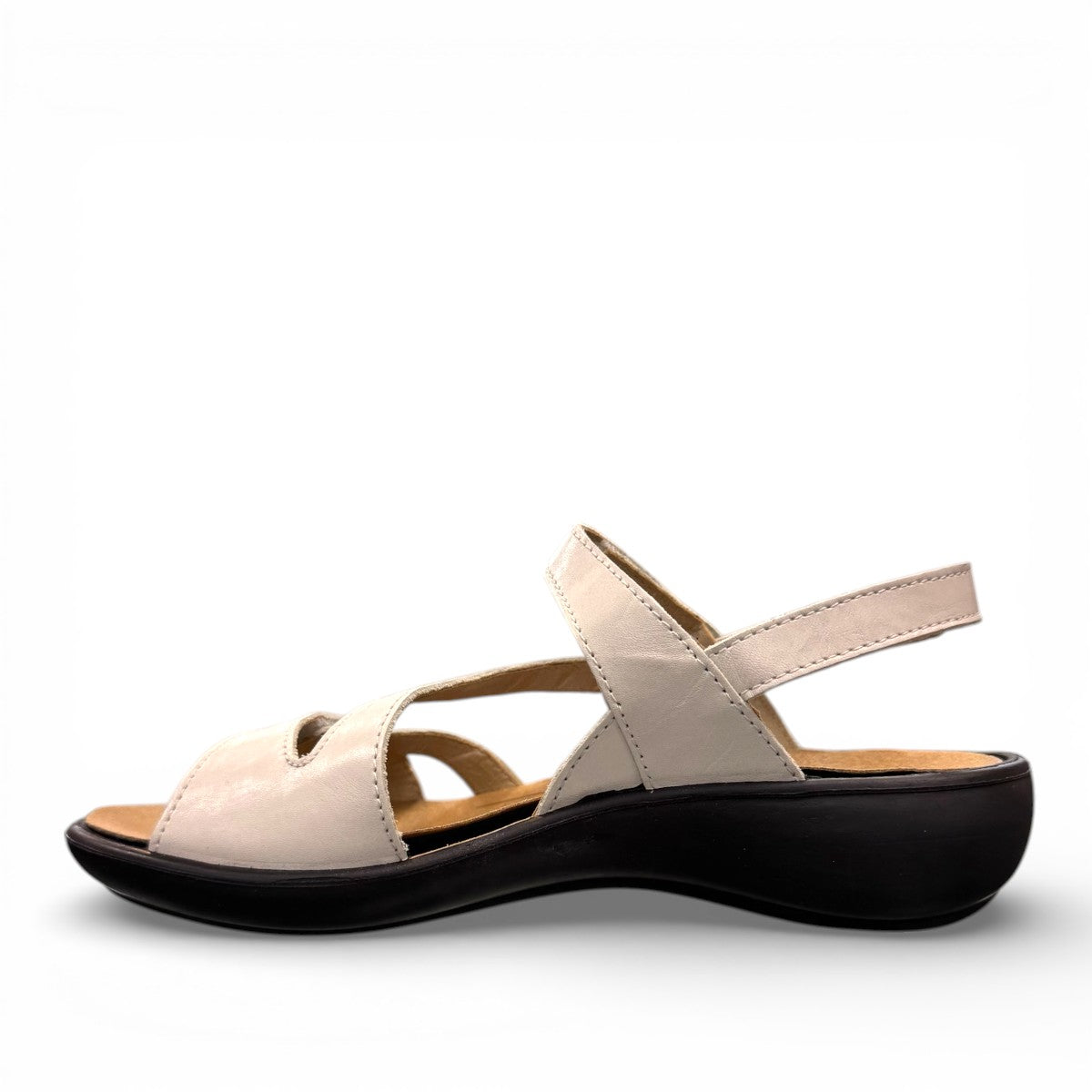 Romika Ibiza 70 white leather sandal with three adjustable hook and loop straps and dark outsole.
photo of the left side