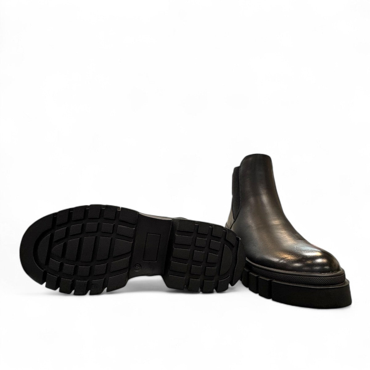 Romika Ruby 01 black vegan leather Chelsea boot with a chunky platform lug sole and elastic side panels.
photo of the bottom side