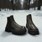 Romika Ruby 01 black vegan leather Chelsea boot with a chunky platform lug sole and elastic side panels.
photo of the front side
