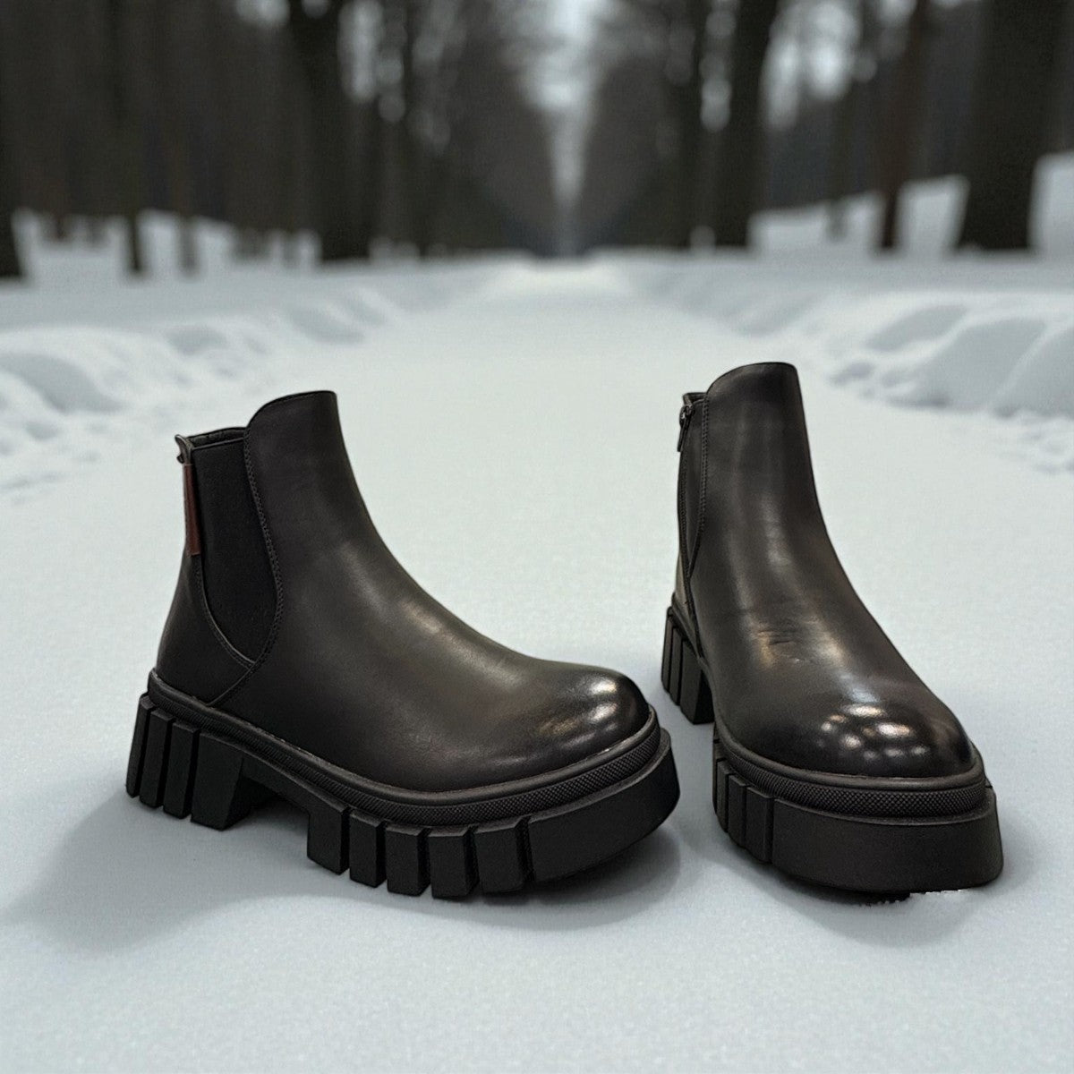 Romika Ruby 01 black vegan leather Chelsea boot with a chunky platform lug sole and elastic side panels.
photo of the front side