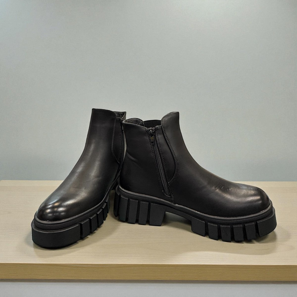 Romika Ruby 01 black vegan leather Chelsea boot with a chunky platform lug sole and elastic side panels.
photo of the front side