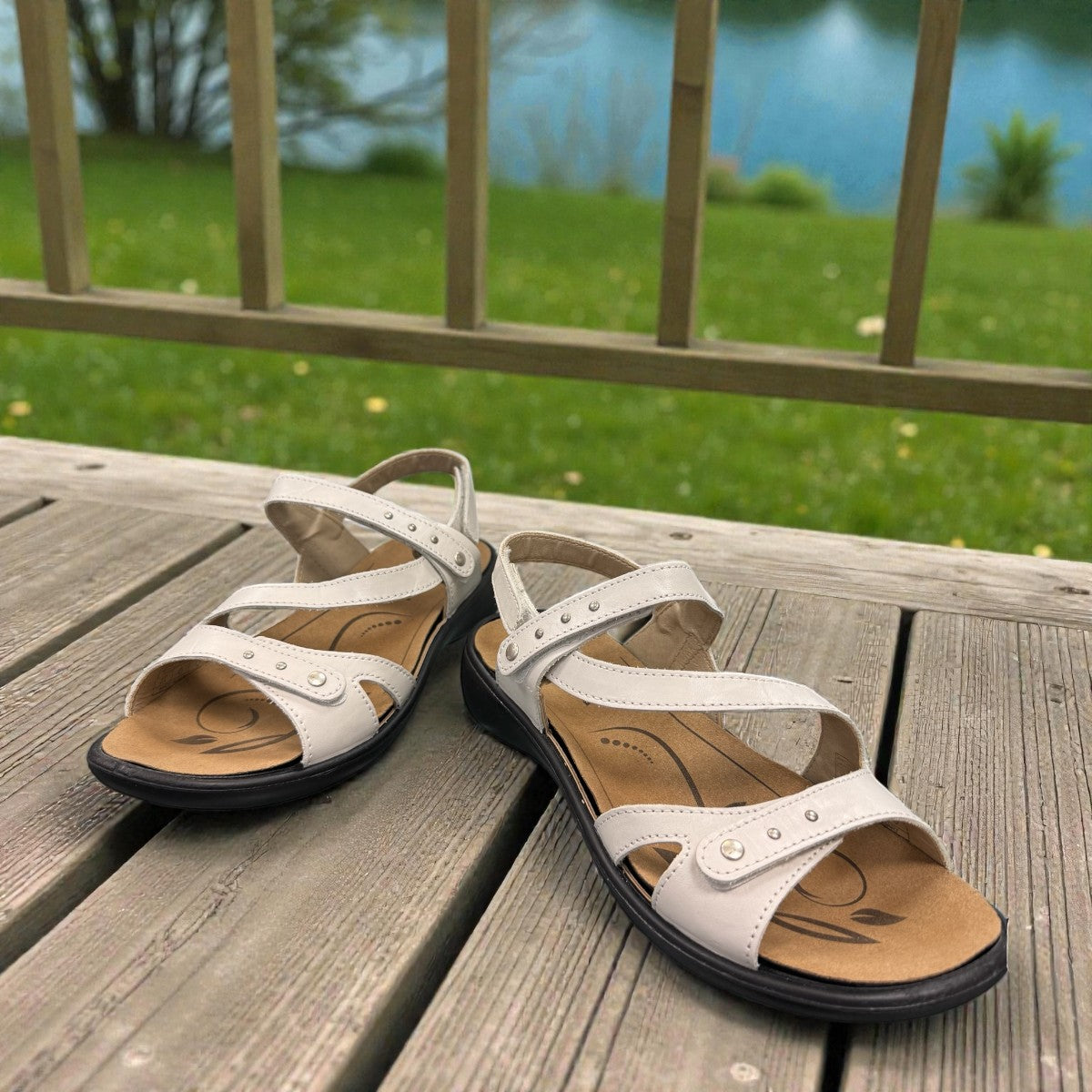 Romika Ibiza 70 white leather sandal with three adjustable hook and loop straps and dark outsole.
photo of the front side