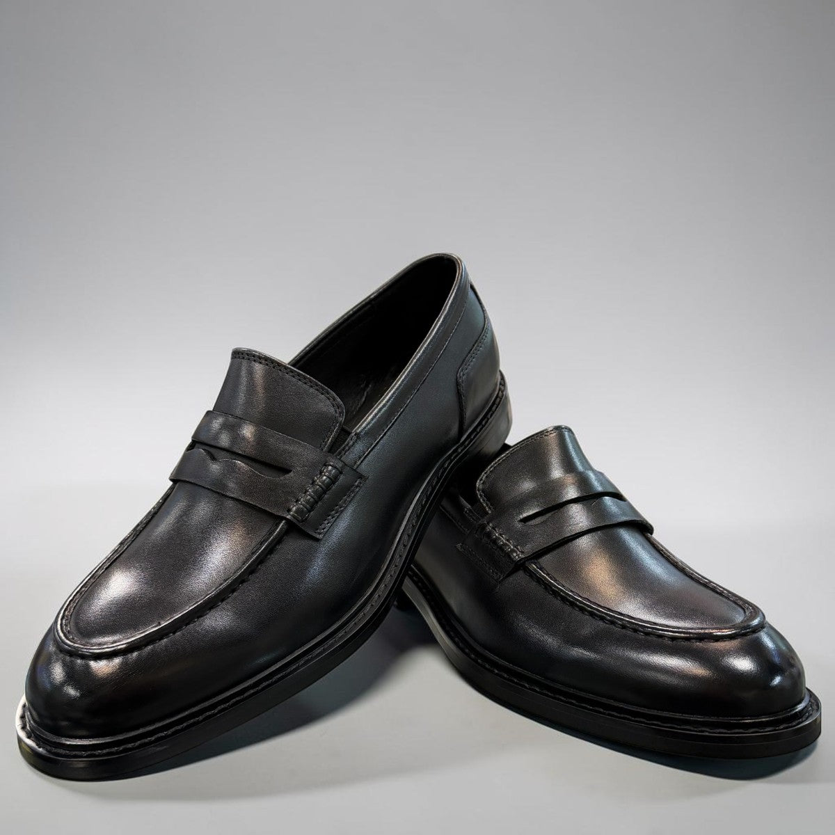 Romitan Tondar black leather slip-on dress shoes with a classic penny loafer design. Photo of front view.