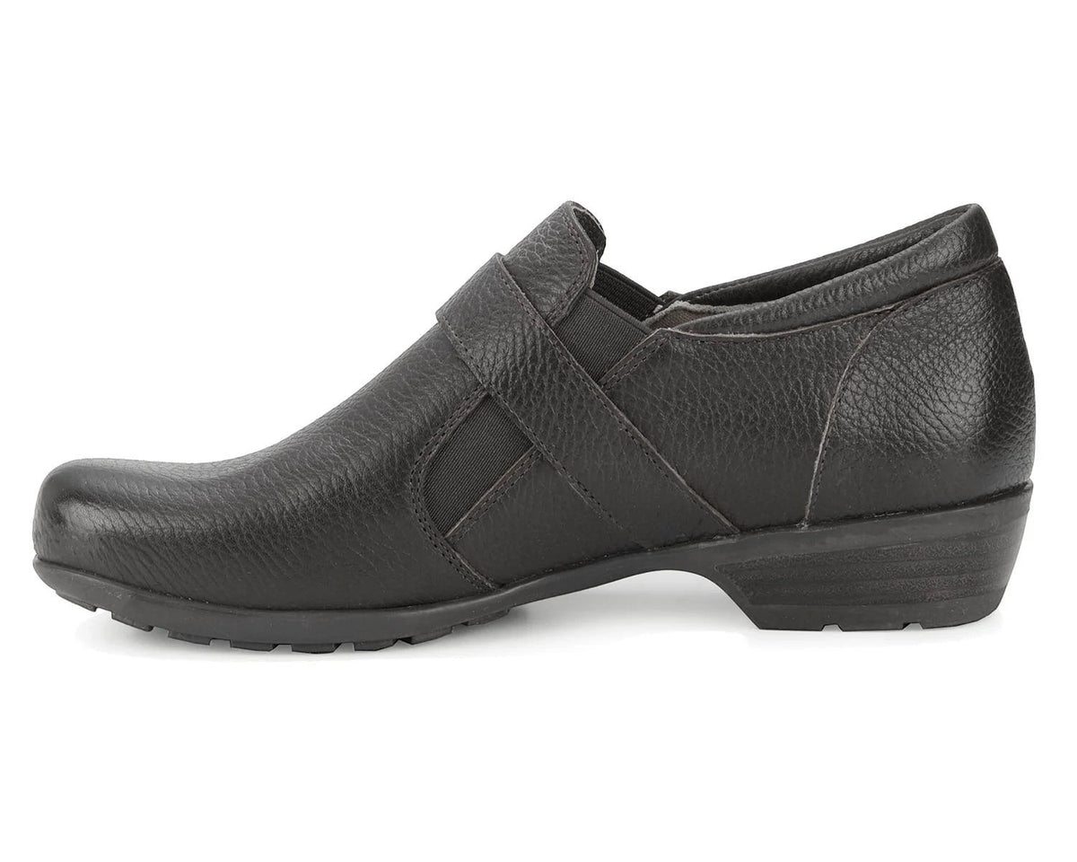 Ros Hommerson Eliot black tumbled leather loafer with adjustable hook and loop strap and low block heel.
photo of the left side