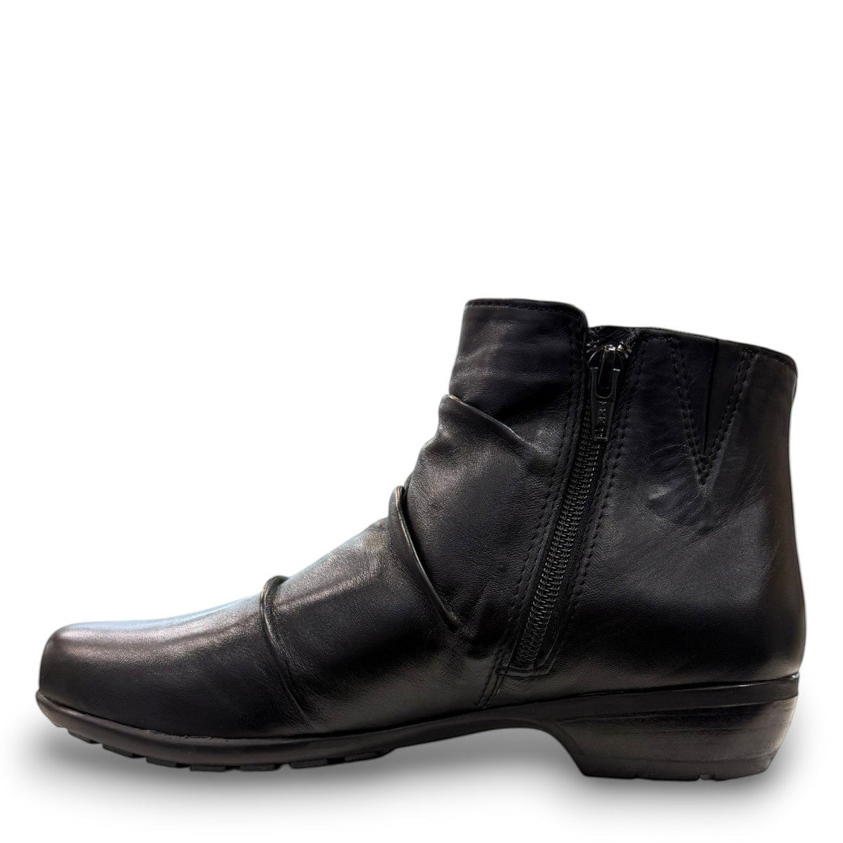 Ros Hommerson Esme black leather ankle bootie with ruched vamp detailing and a low stacked heel.
photo of the left side