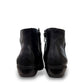 Ros Hommerson Esme black leather ankle bootie with ruched vamp detailing and a low stacked heel.
photo of the back side