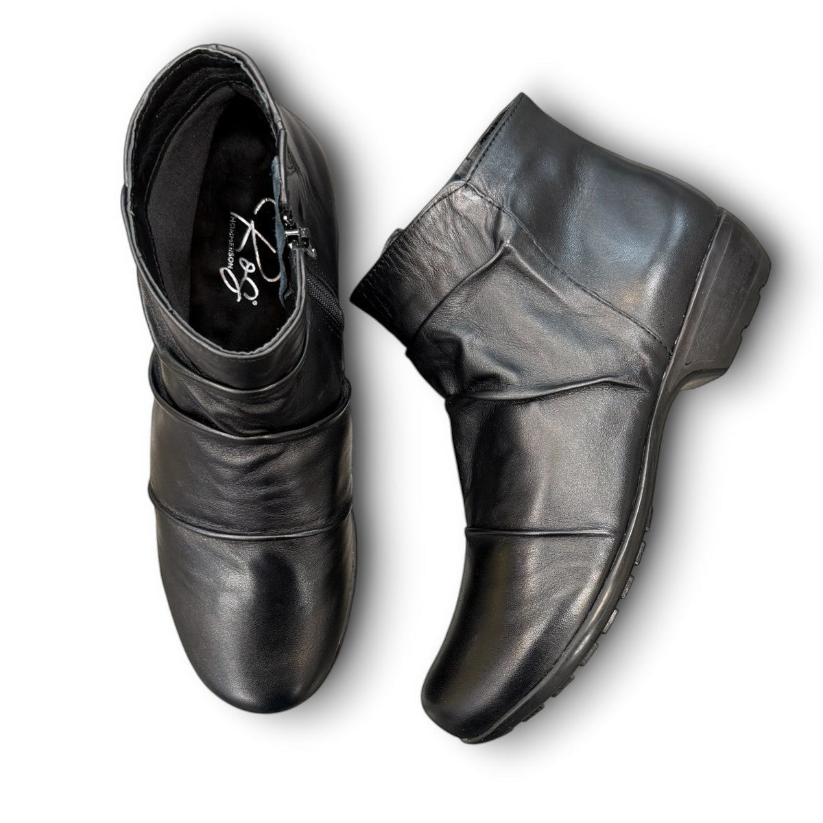 Ros Hommerson Esme black leather ankle bootie with ruched vamp detailing and a low stacked heel.
photo of the top side