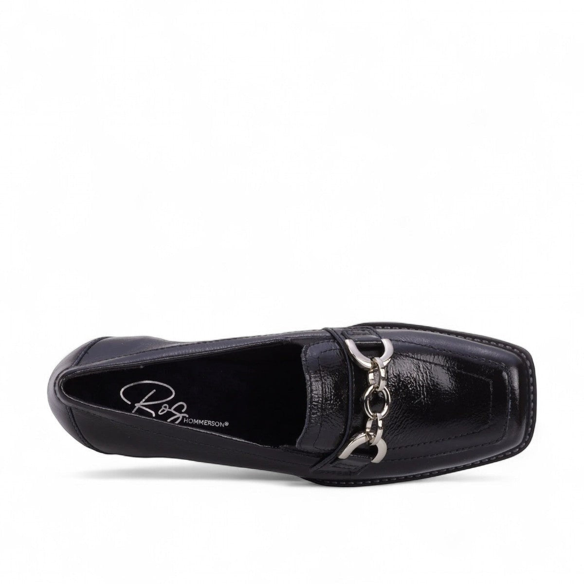 Ros Hommerson Evie black shiny tumbled leather loafer with square toe, chain detail, and block heel.
photo of the top side