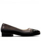 Sabatini of Florence SF1 black slip-on shoe with a glossy cap-toe and low block heel.
photo of the right side