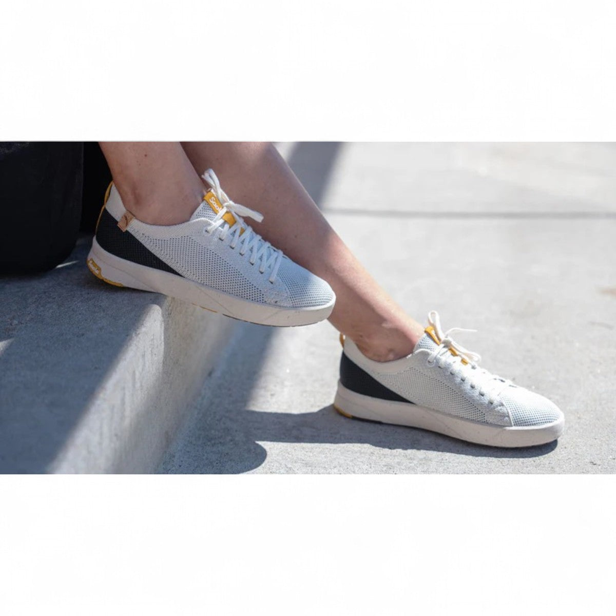 SAOLA Cannon Knit 2.0 sneaker in white and black with a sustainable recycled knit upper and cork details. Photo of side views.