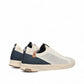 SAOLA Cannon Knit 2.0 sneakers in white and navy with a sustainable recycled knit upper and cork detail. Photo of back side views.