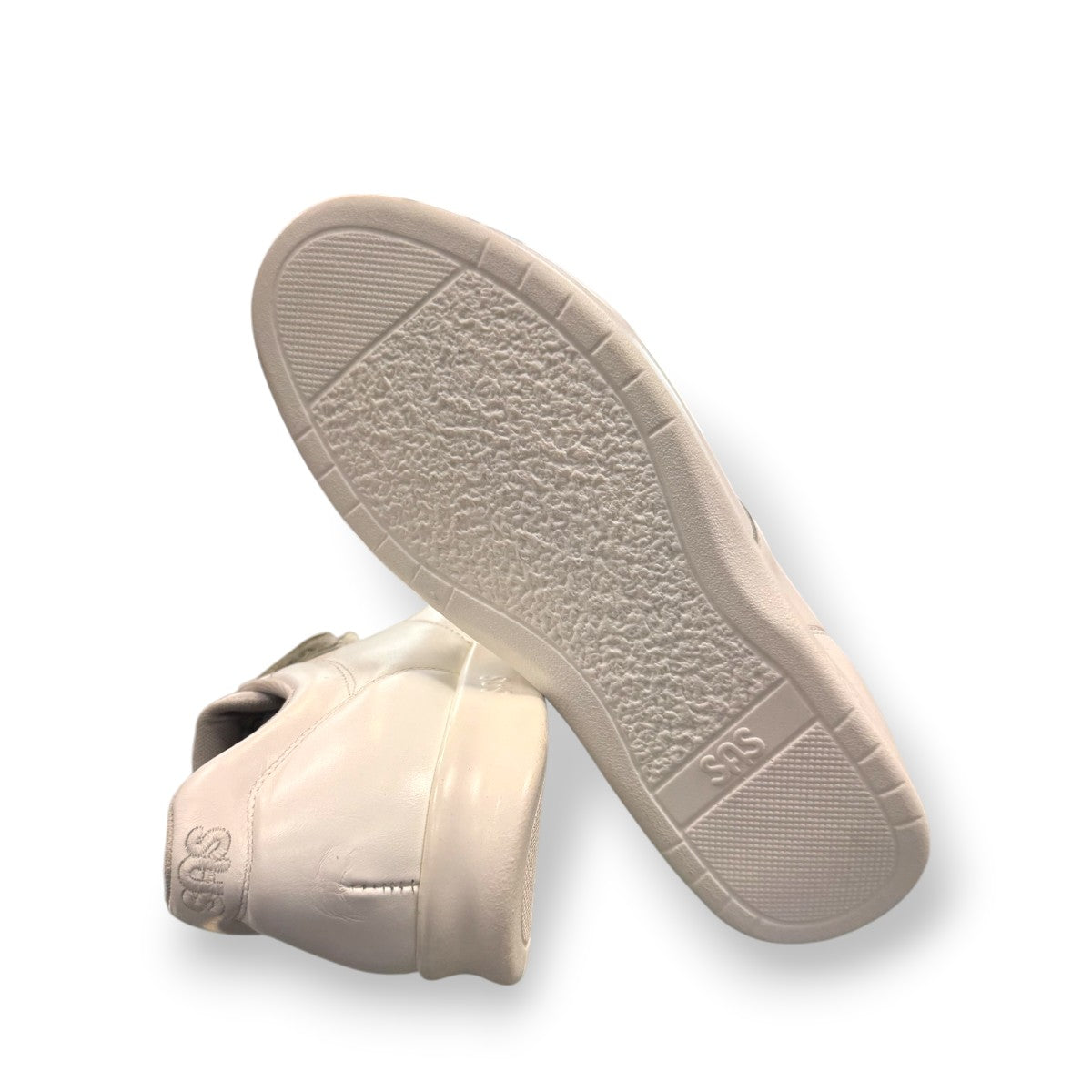 SAS Me Too white leather athletic walking shoe with adjustable EZ straps and cushioned sole.
photo of the bottom side