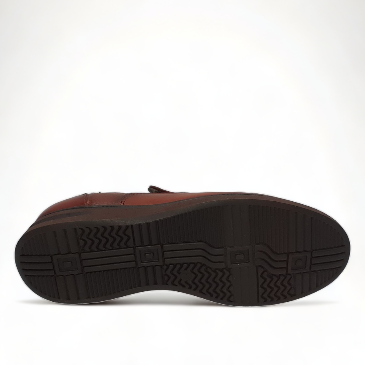 SHAHIN NEOR brown leather slip-on men's shoes with a textured upper and durable rubber outsole. Photo of bottom view.