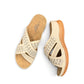 Sina Footwear beige vegan leather slide sandals with floral cut-out straps and a cushioned comfort sole.
photo of the top side