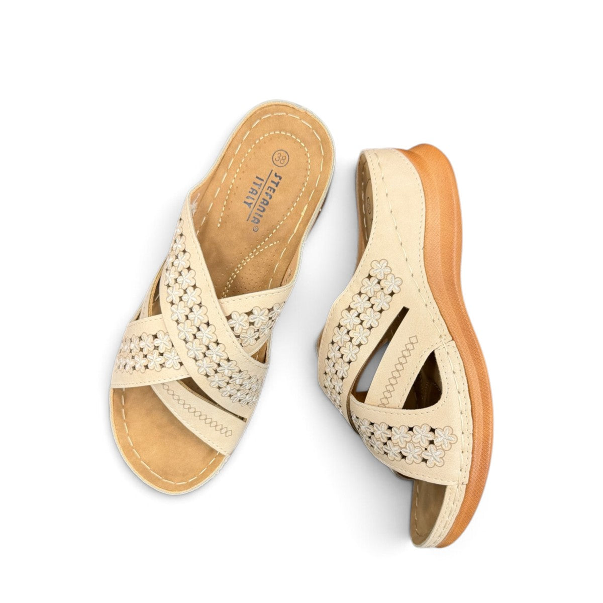 Sina Footwear beige vegan leather slide sandals with floral cut-out straps and a cushioned comfort sole.
photo of the top side