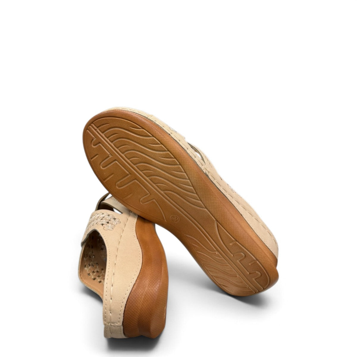 Sina Footwear beige vegan leather slide sandals with floral cut-out straps and a cushioned comfort sole.
photo of the bottom side
