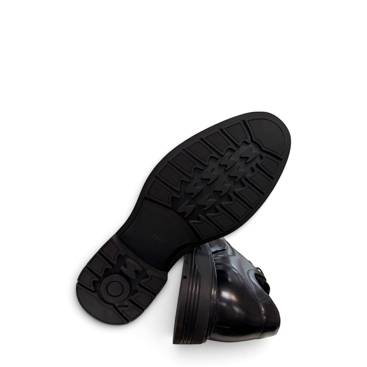 Sina Footwear black leather derby shoe with brogue-inspired perforations and a lightweight chunky rubber sole.
photo of the bottom side