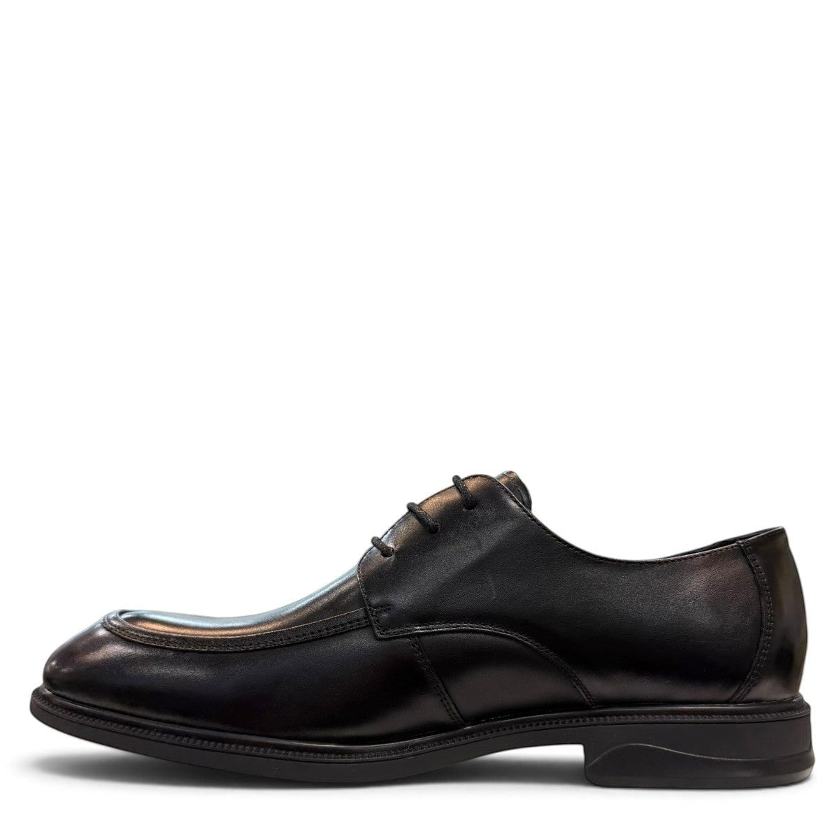 Sina Footwear black leather derby shoes with apron-toe construction, lace-up closure, and durable rubber outsole.
photo of the left side