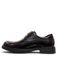 Sina Footwear black leather derby shoe with brogue-inspired perforations and a lightweight chunky rubber sole.
photo of the left side