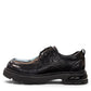 Sina Footwear black leather derby shoe with a chunky lug sole and lace-up closure in a modern silhouette.
photo of the left side