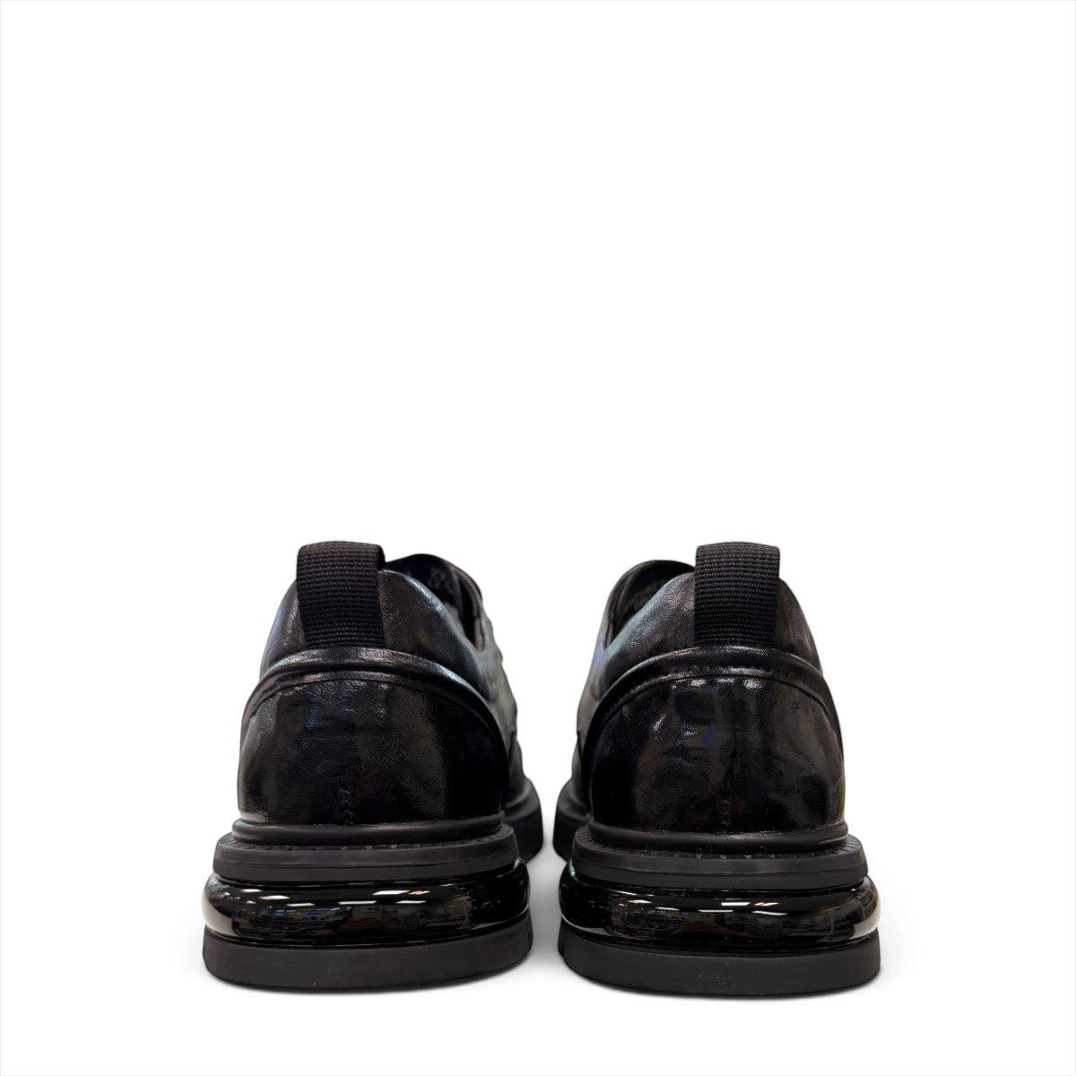 Sina Footwear black leather derby shoe with a chunky lug sole and lace-up closure in a modern silhouette.
photo of the back side