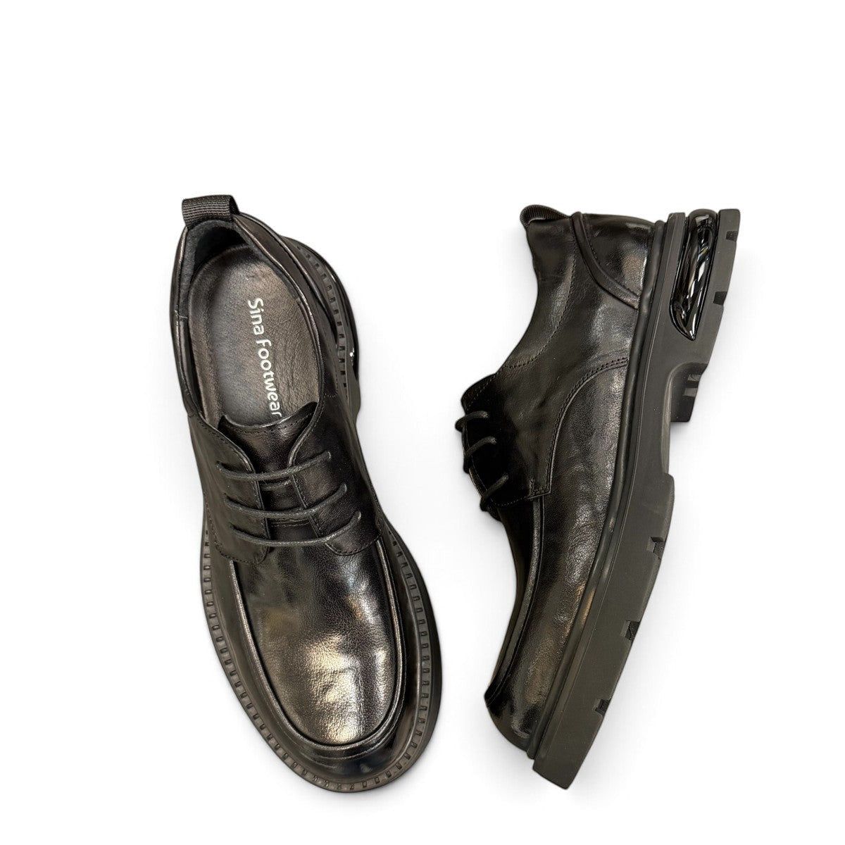 Sina Footwear black leather derby shoe with a chunky lug sole and lace-up closure in a modern silhouette.
photo of the top side