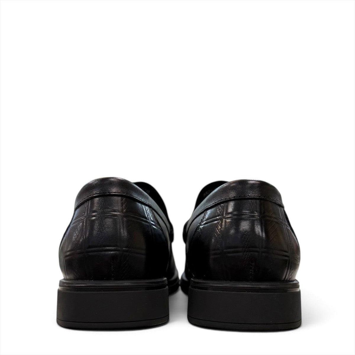 Sina Footwear black genuine leather loafers with a crocodile-embossed texture and a sleek slip-on design.
photo of the back side