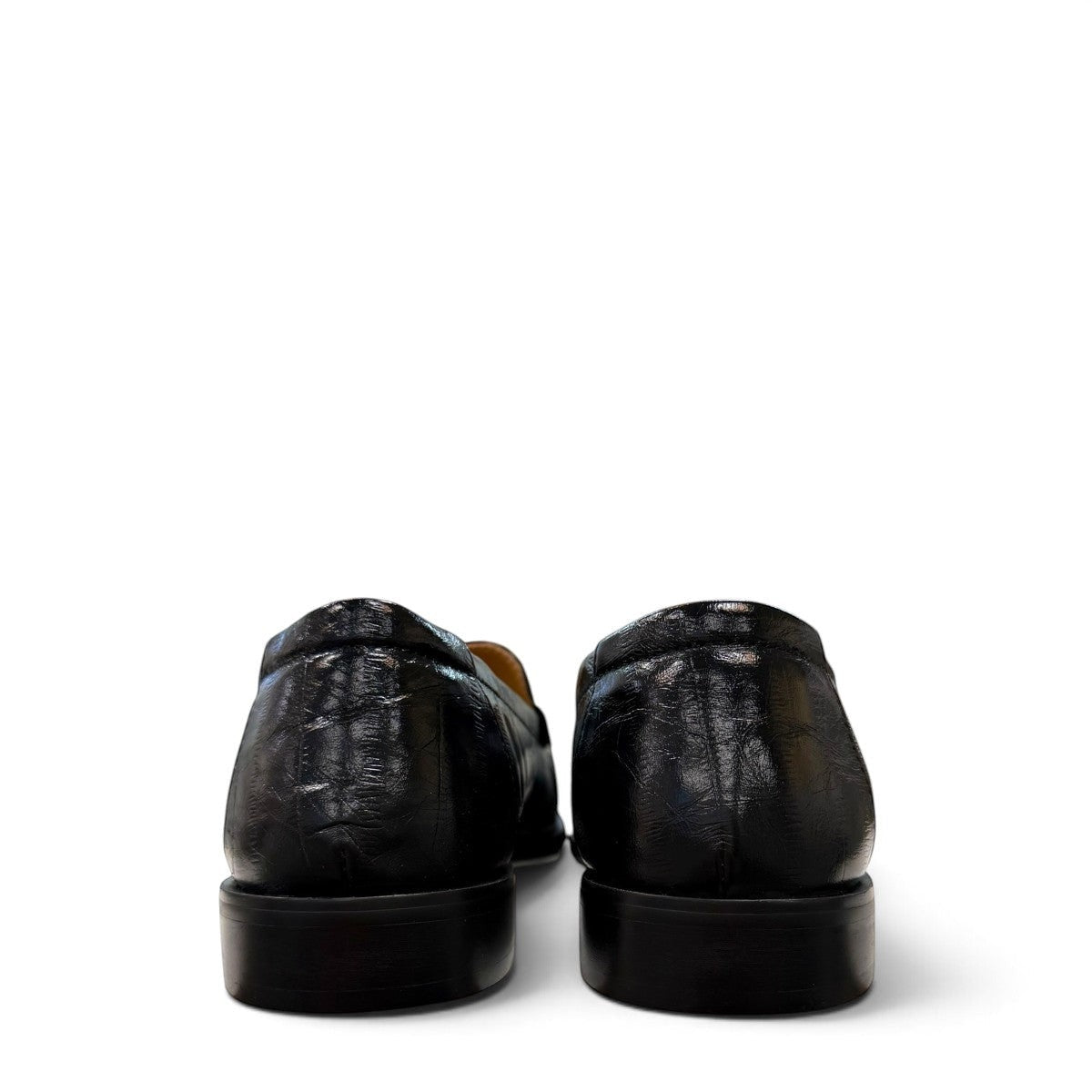 Sina Footwear black genuine leather slip-on loafer with hand-finished gathered detailing and a durable rubber outsole.
photo of the back side