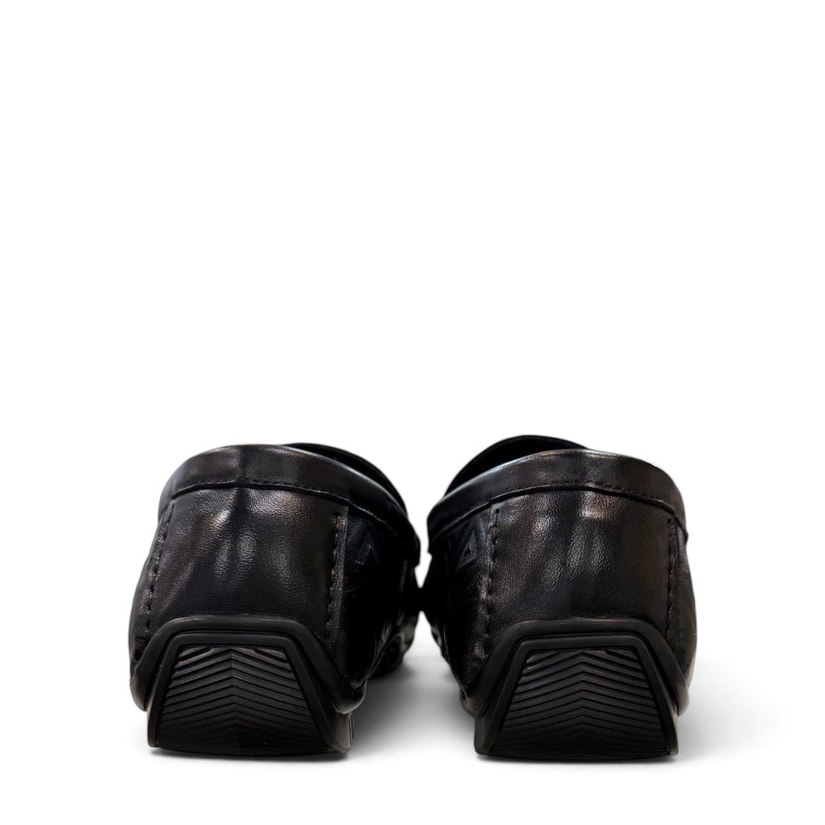 Sina Footwear black genuine leather loafer with embossed geometric pattern and slip-on design.
 photo of the back side