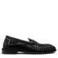 Sina Footwear black genuine leather slip-on loafer with hand-finished gathered detailing and a durable rubber outsole.
photo of the right side