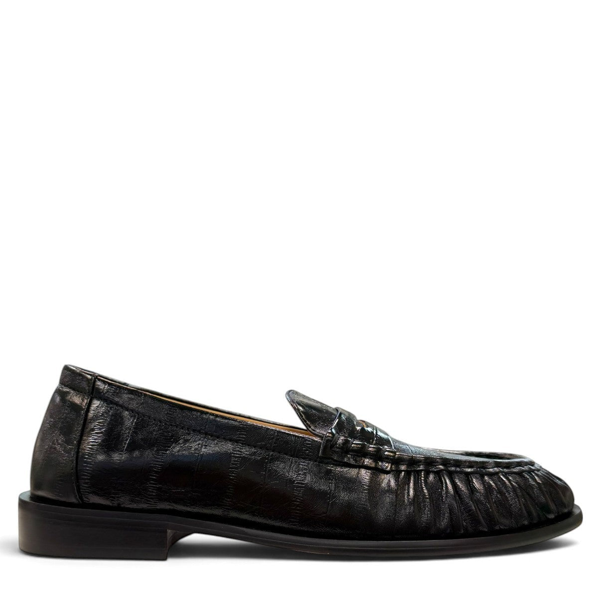 Sina Footwear black genuine leather slip-on loafer with hand-finished gathered detailing and a durable rubber outsole.
photo of the right side