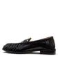 Sina Footwear black genuine leather slip-on loafer with hand-finished gathered detailing and a durable rubber outsole.
photo of the left side