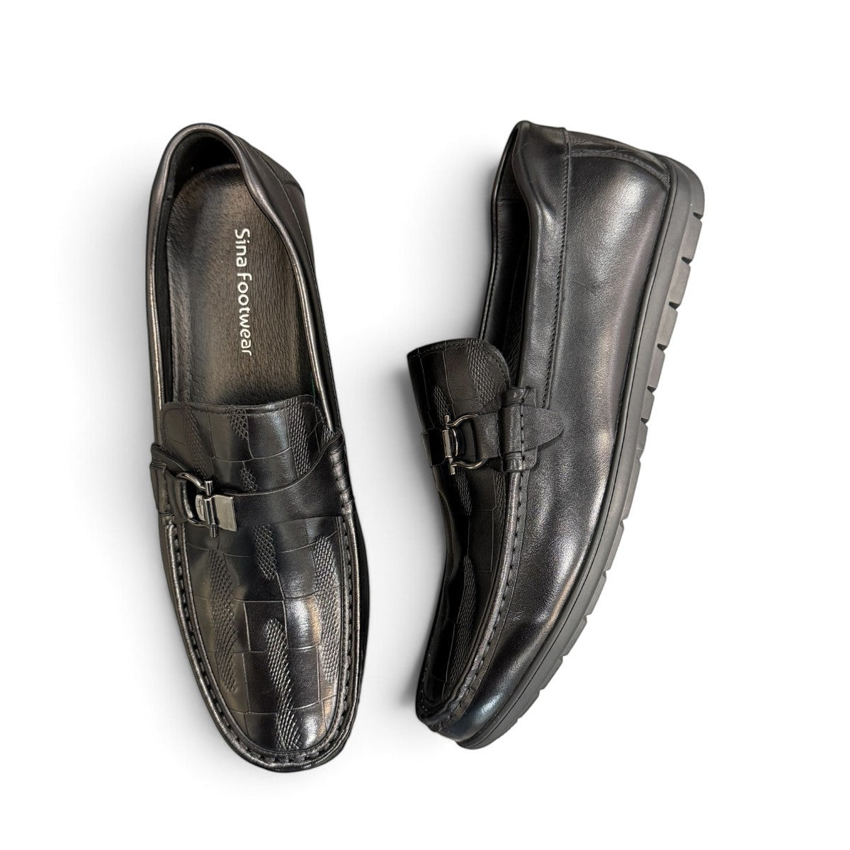 Sina Footwear black genuine leather loafer with a textured vamp strap and durable rubber outsole.
photo of the top side