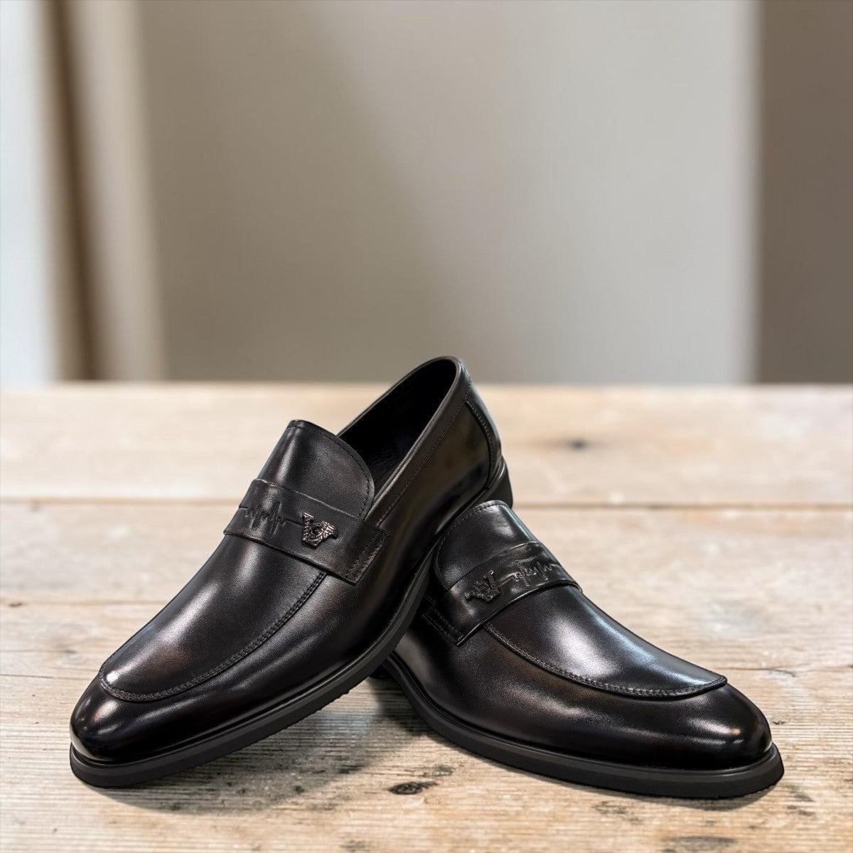 Sina Footwear black genuine leather loafer with a classic silhouette, slip-on design, and durable rubber outsole.
photo of the front side