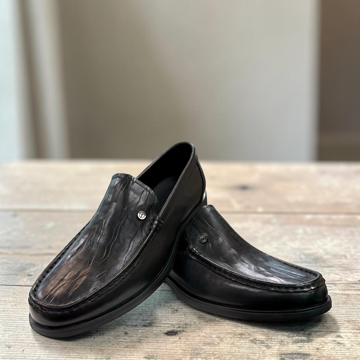 Sina Footwear black genuine leather loafer with a classic silhouette, stitched detailing, and durable rubber outsole.
photo of the front side