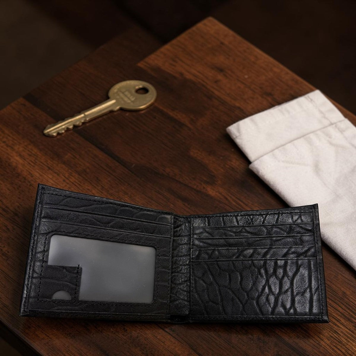 Sina Footwear genuine leather bi-fold wallet in black with multiple card slots and ID window.
