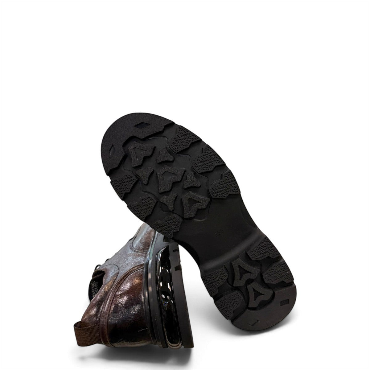 Sina Footwear dark brown leather derby shoe with a chunky black lug sole and lace-up closure.
photo of the bottom side