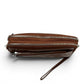 Sina Footwear brown genuine leather wallet with multiple zippered compartments and a wrist strap. Quilted detail on front pocket.