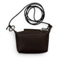 Sina Footwear dark brown pebbled leather mini crossbody wallet with a silver zipper and adjustable strap.