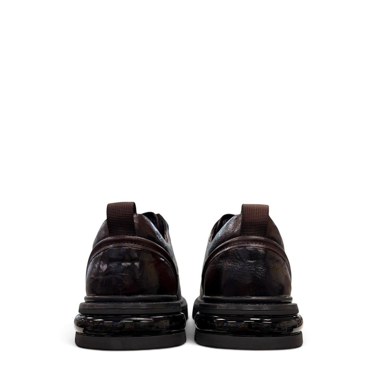 Sina Footwear dark brown leather derby shoe with a chunky black lug sole and lace-up closure.
photo of the back side