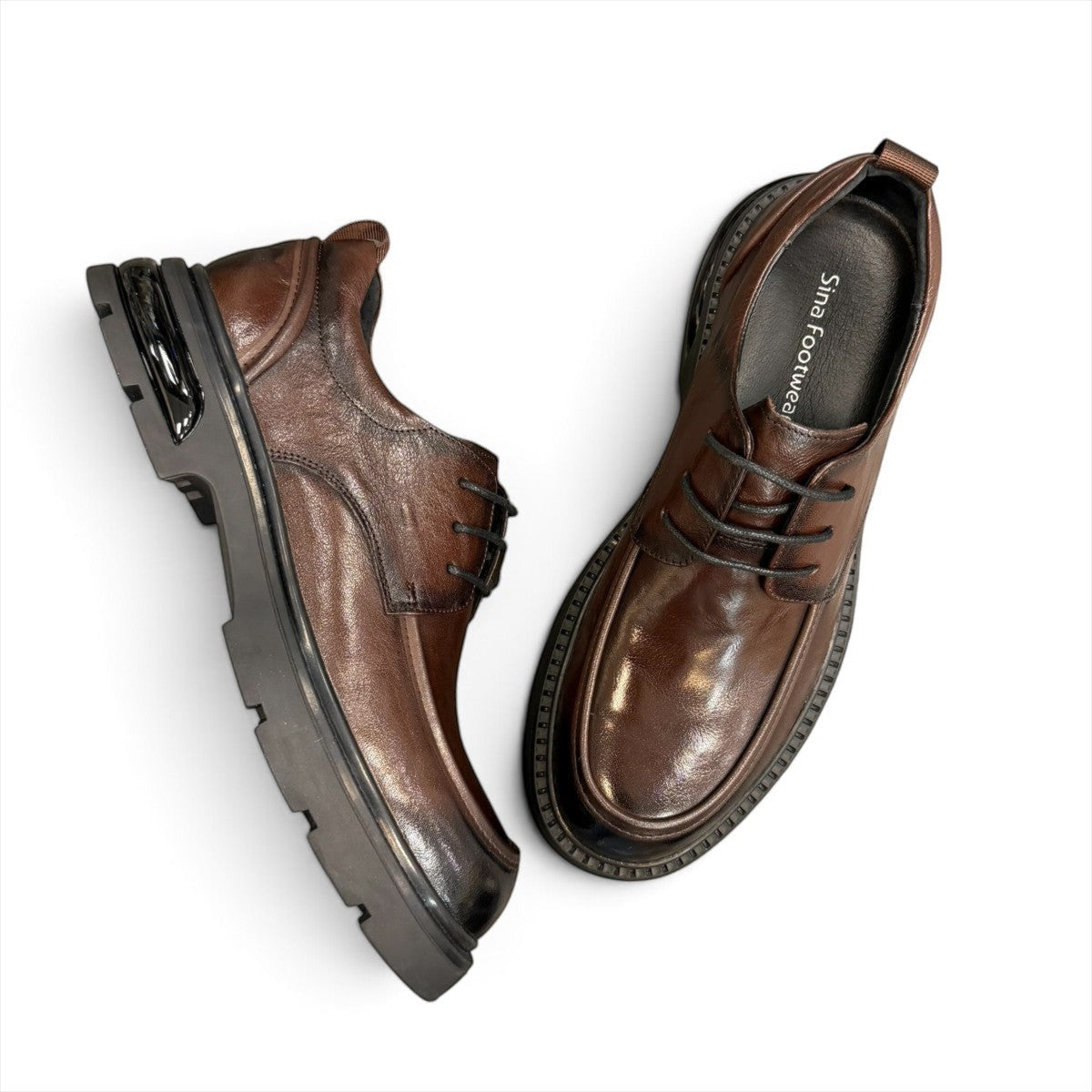 Sina Footwear dark brown leather derby shoe with a chunky black lug sole and lace-up closure.
photo of the top side