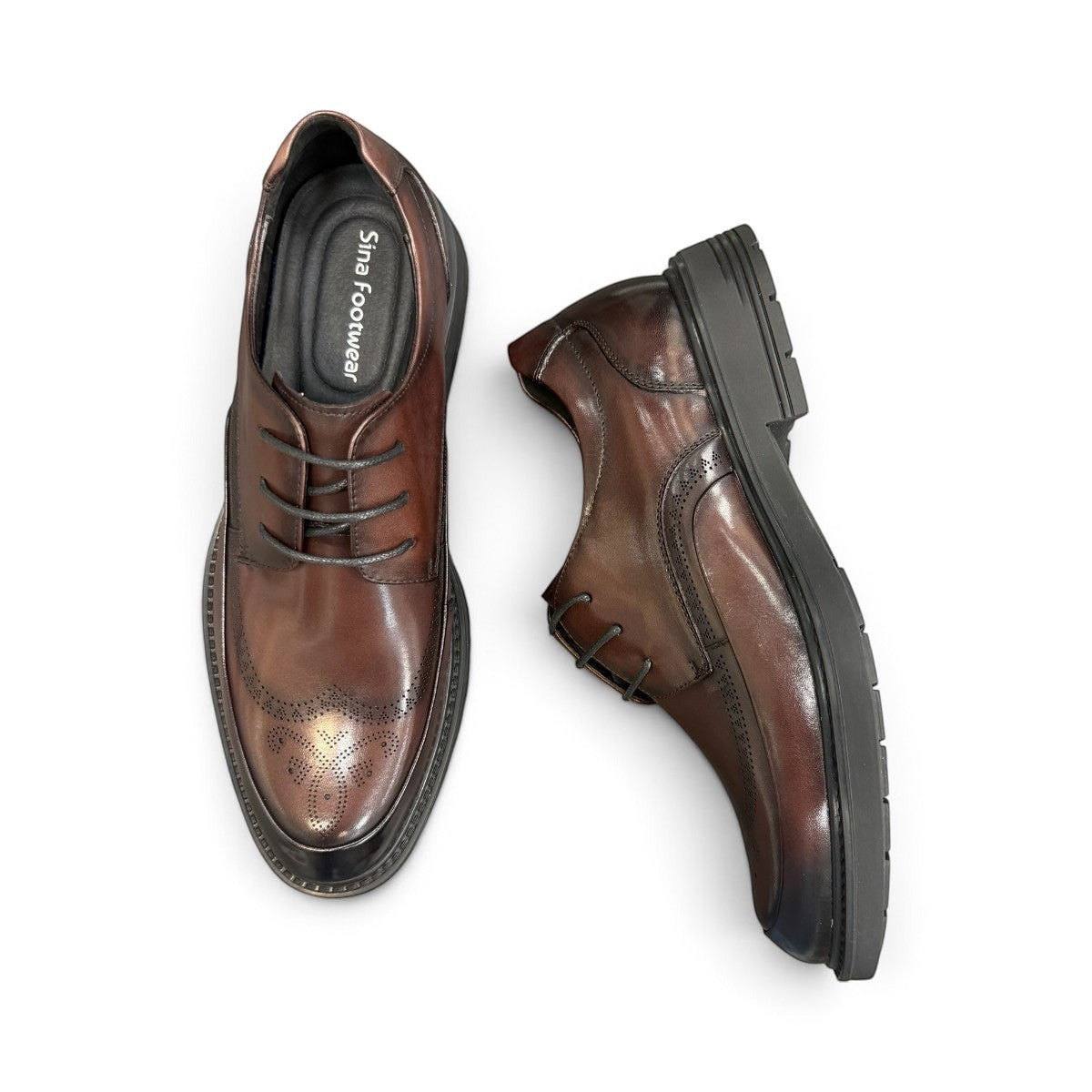 Sina Footwear dark brown leather derby shoe with brogue-inspired perforated details and a lightweight chunky sole.
 photo of the top side