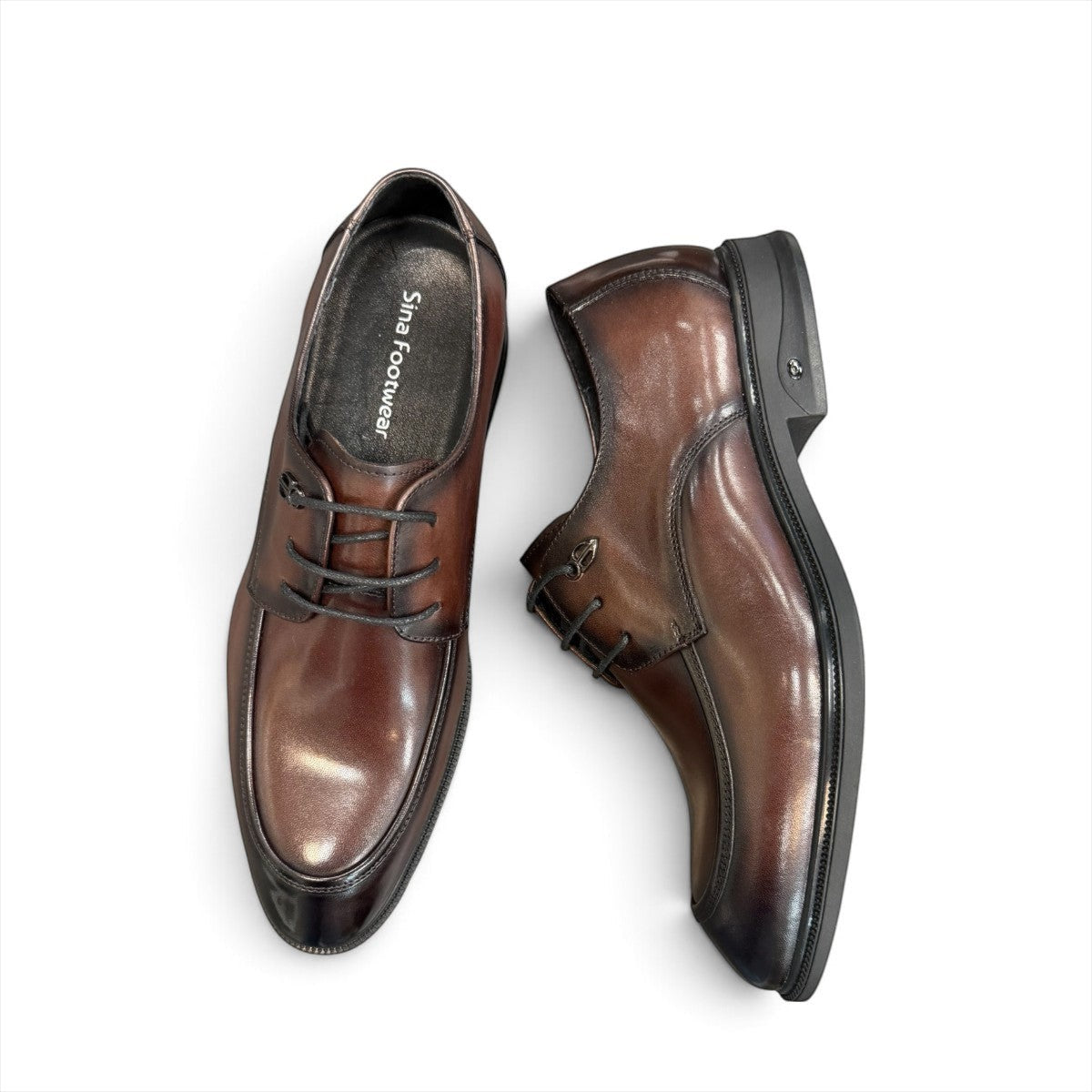 Sina Footwear dark brown leather derby shoe with apron-toe construction and lace-up design on a white background.
photo of the top side