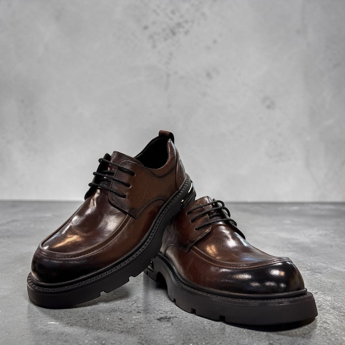 Sina Footwear dark brown leather derby shoe with a chunky black lug sole and lace-up closure.
photo of the front side