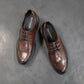 Sina Footwear dark brown leather derby shoe with brogue-inspired perforated details and a lightweight chunky sole.
 photo of the top side