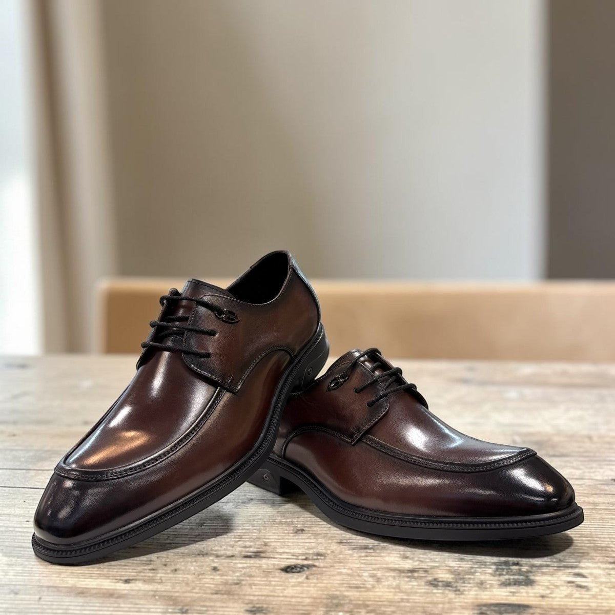 Sina Footwear dark brown leather derby shoe with apron-toe construction and lace-up design on a white background.
photo of the front side