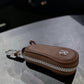 Sina Footwear dark brown leather key holder wallet with silver zipper and metal clip. Compact and stylish for everyday use.